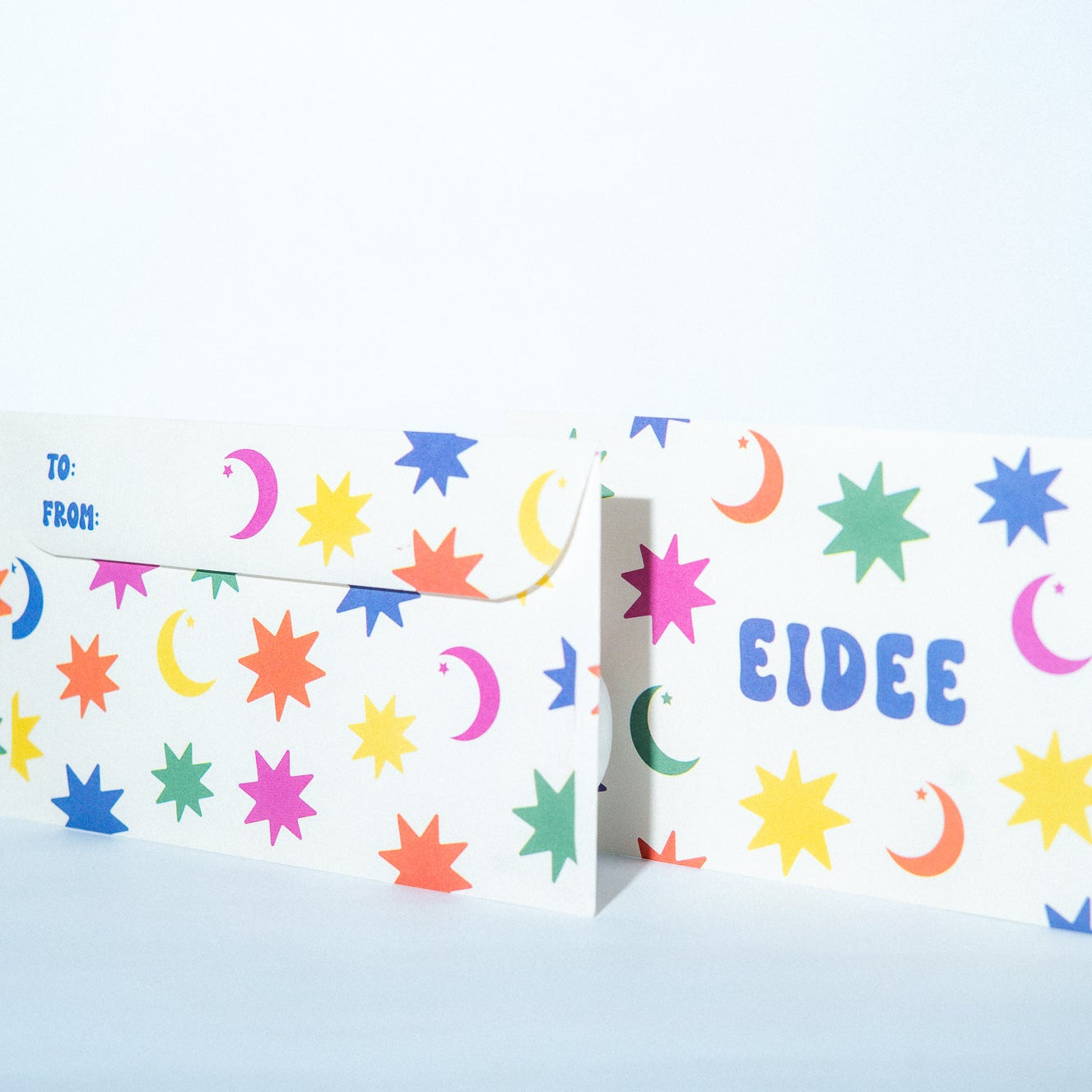 Colorful patterned card with 'EIDEE' branding on a light blue background