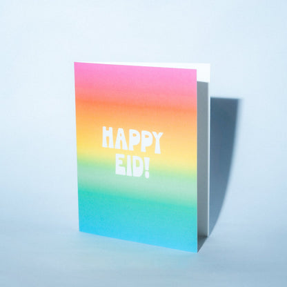 Colorful card with 'Happy Eid!' text on a light blue background