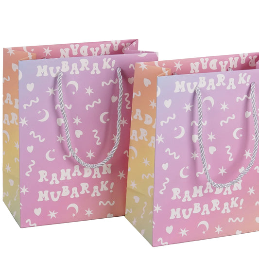 Two pastel-colored gift bags with 'Ramadan Mubarak!' text on a light background