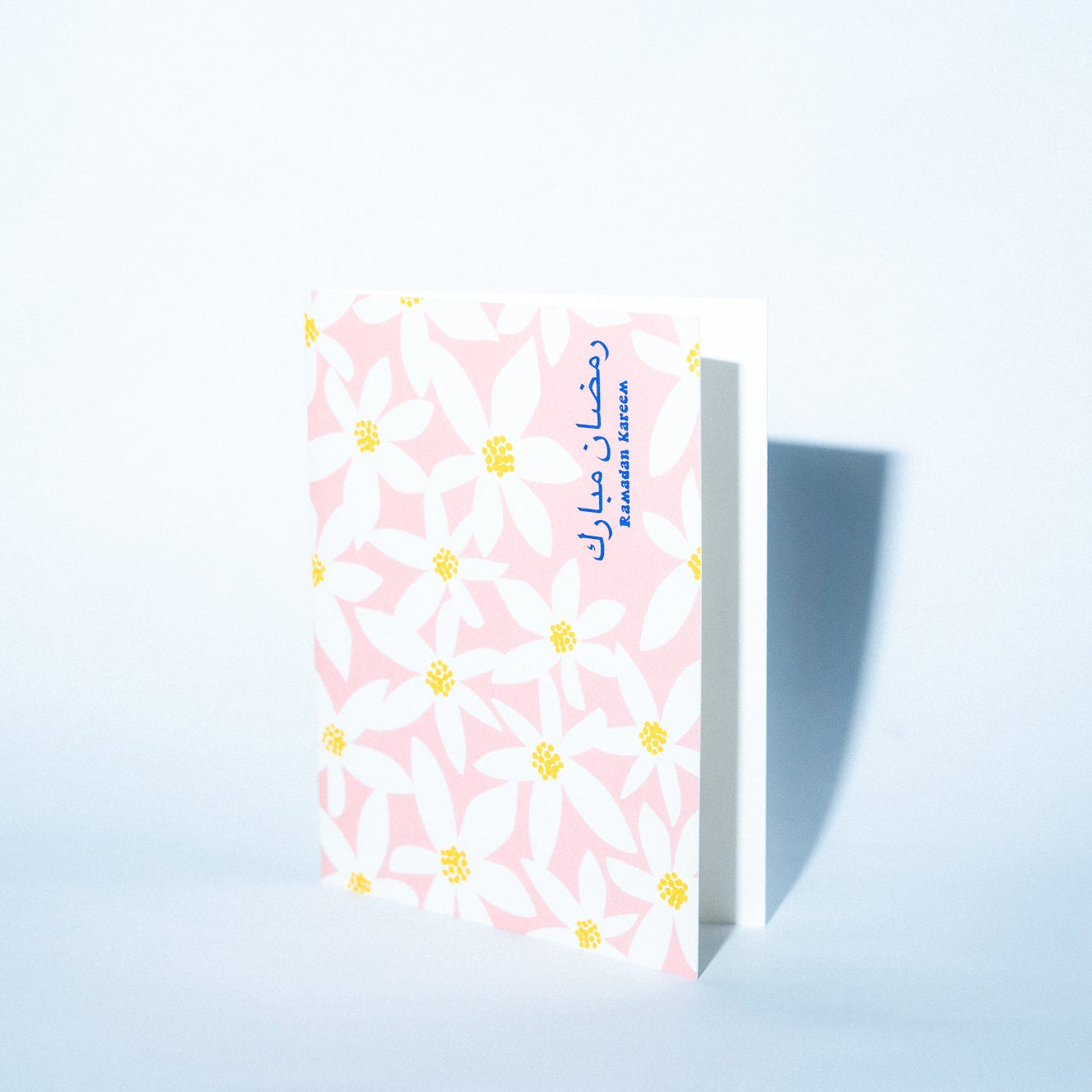 Small rectangular product with a pink floral pattern on a light blue background