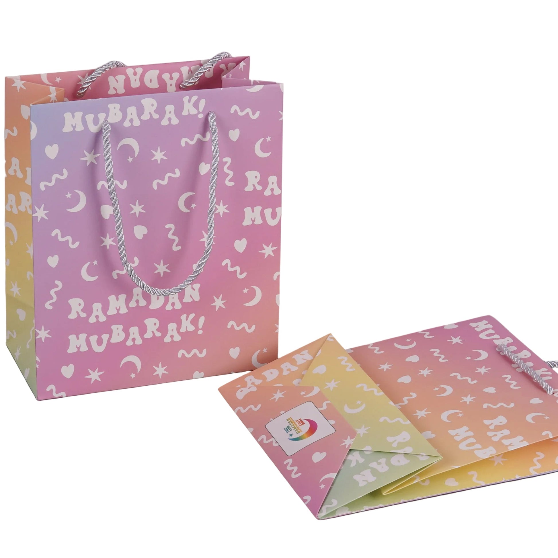 Decorative gift bag with 'Ramadan Mubarak!' text and matching envelopes on a white background